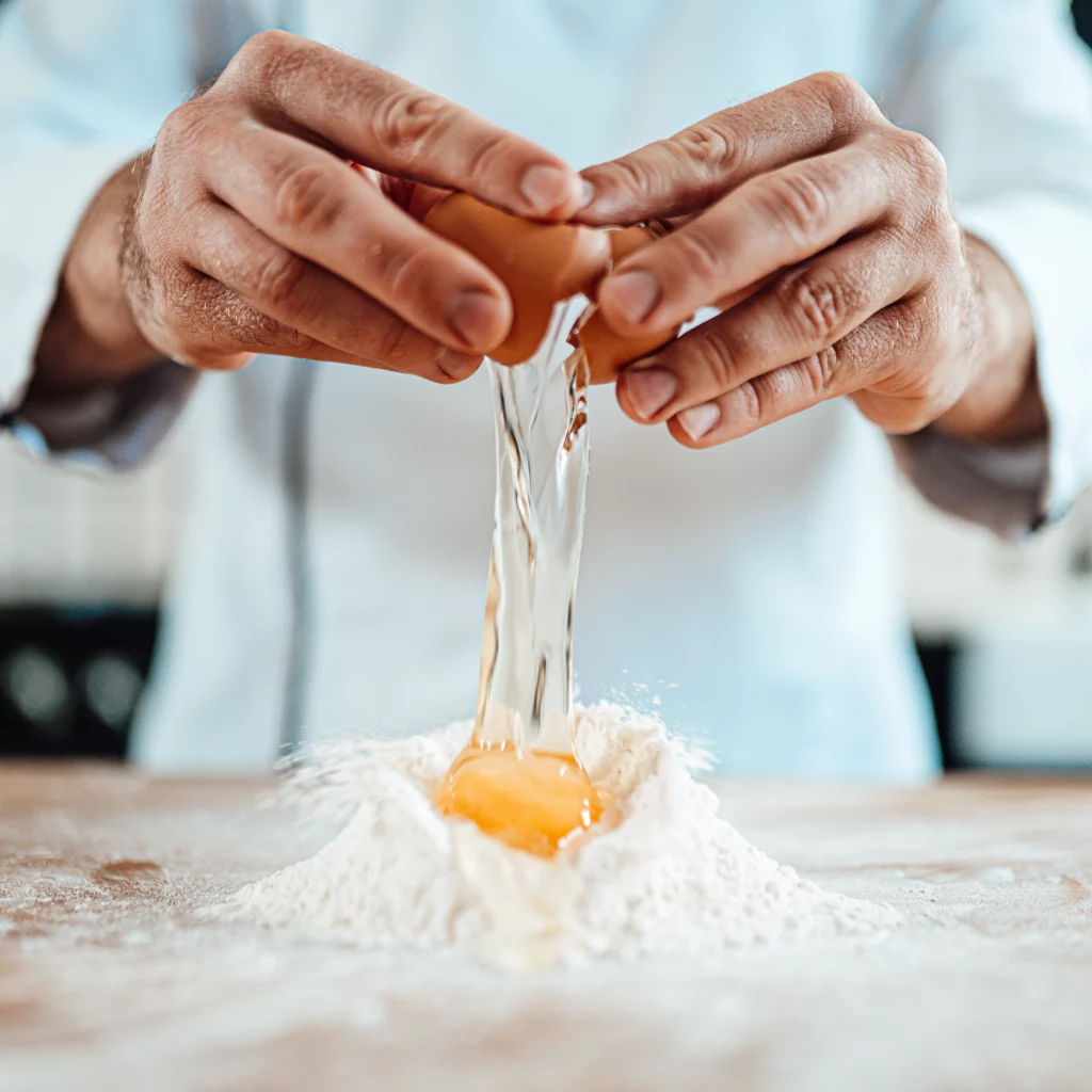 French Pastry Technique - Cooking Class Dubai French cooking class Dubai demonstrating pastry technique with egg for pâte brisée