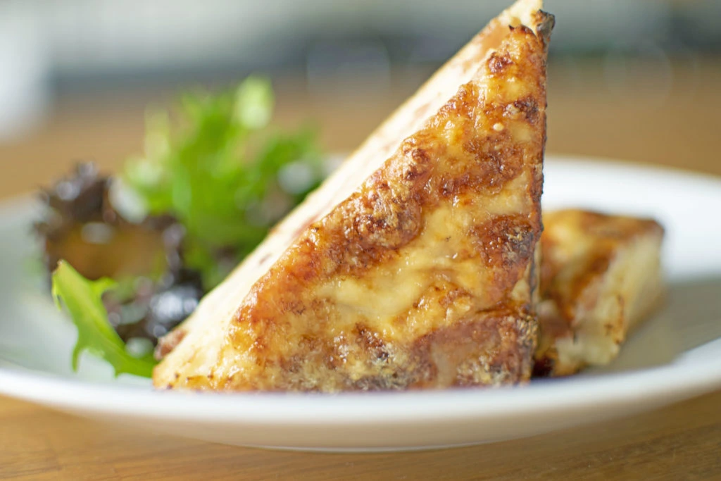 Truffle Croque Monsieur by French Private Chef Dubai French private chef Dubai preparing truffle croque monsieur for gastronomic dinner experience